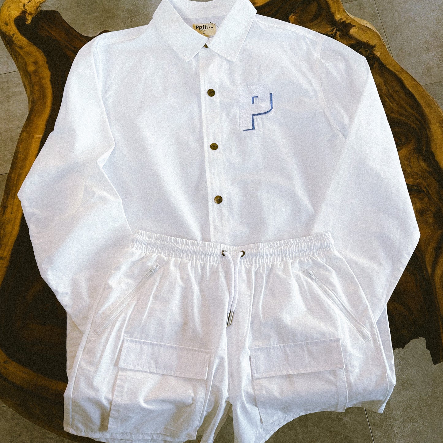 White cotton and nylon blend shorts on display with matching white coach jacket, spring, summer essentials, resort, menswear, pockets.